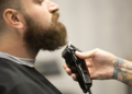 men shaving himself with an electric razor